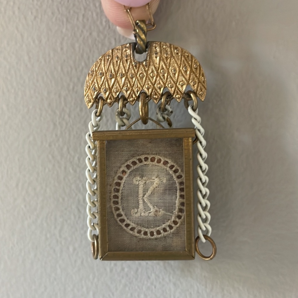 Vintage necklace with “K” petite doilies in box frame. 20” crochet clasp.